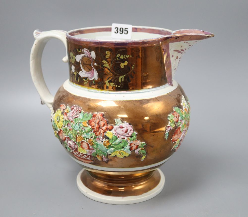 A Victorian pink and copper lustre jug, with moulded floral panels, height 23cm (crack to base)